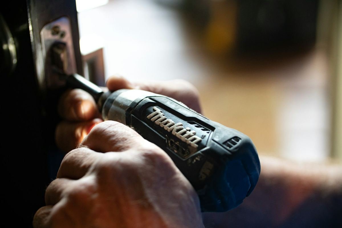 Cordless drill in hand, close up