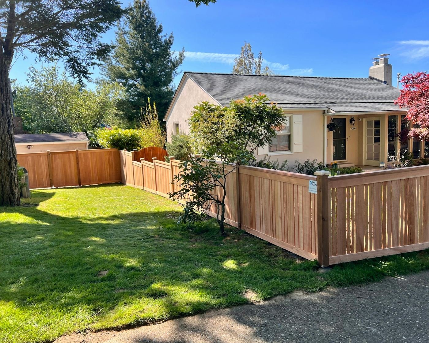 Suburban home with a new cedar privacy fence in the front yard